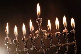 Lit candles in menorah