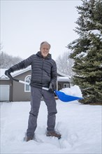 Senior man shoveling snow