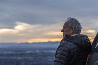 Senior man looking at view during sunset