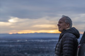 Senior man looking at view during sunset