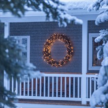 Illuminated Christmas wreath on house during winter