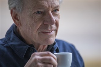 Senior man with coffee cup