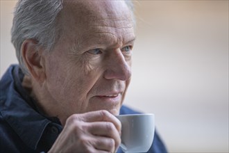 Senior man with coffee cup