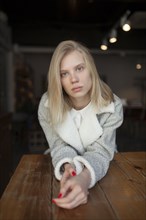 young woman sitting at cafe table