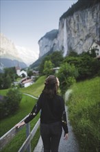 young woman on path by mountain