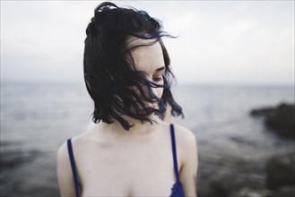 young woman on windy beach