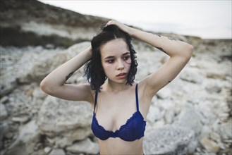 young woman with blue bra on beach