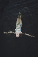 young woman floating in water