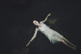 young woman floating in water