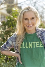 Portrait of smiling woman in volunteer t-shirt