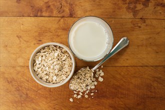 Oats and oat milk against wood