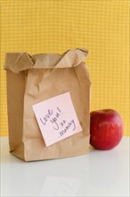 School lunch in paper bag with note from mom