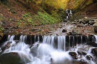 Ukraine, Zakarpattia region, Carpathians, Verkhniy Shypot waterfall, Blurred waterfall in autumn woods