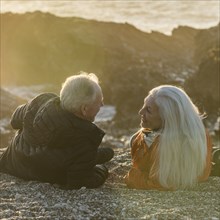 Senior couple enjoying sunset on beach