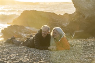 Senior couple enjoying sunset on beach
