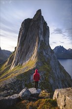 Norway, Senja, Man standing in front of Segla mountain at sunrise