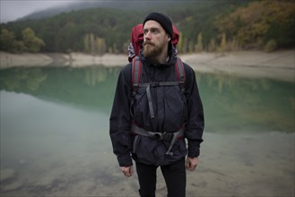 Italy, Man standing in front of lake