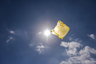 Yellow plastic bag in sky