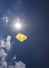 Yellow plastic bag in sky