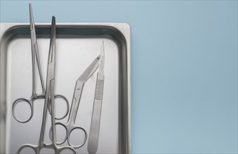 Forceps and scalpel on tray