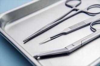 Forceps and scalpel on tray