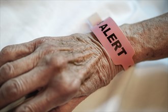 Alert tag around senior person's wrist