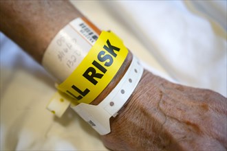 'Fall risk' tag around senior person's wrist