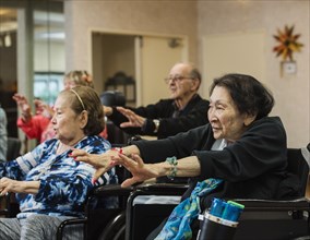 Senior people stretching in wheelchairs