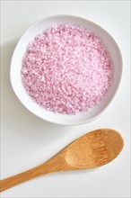 Bath salt in bowl and wooden spoon