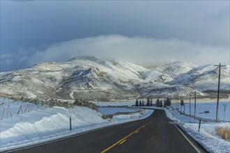 Road with snowy mountains in distance