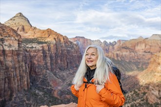 Smiling woman by canyon at Zion National Park in Utah, USA