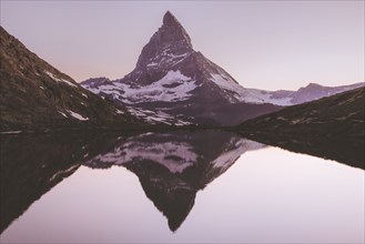 Matterhorn mountain and lake at sunrise in Valais, Switzerland