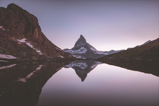 Matterhorn mountain and lake at sunrise in Valais, Switzerland