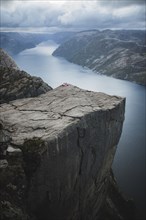 Tent in distance on Preikestolen cliff in Rogaland, Norway