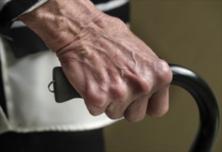 Close up of hand of senior woman holding cane