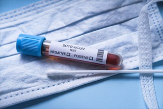 Coronavirus test vial with surgical mask and swab