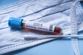Vial of covid-19 Coronavirus test and surgical mask