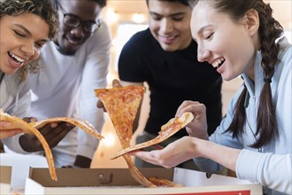 Group of friends having pizza together