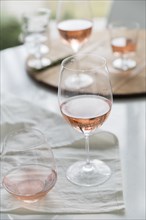 Glasses of rose wine on table
