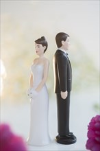 Bride and Groom cake toppers facing away from each other
