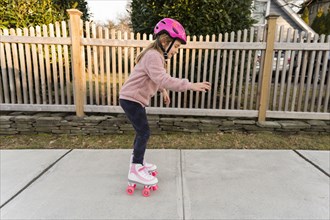 Girl learning how to rollerskate