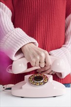 Woman holding vintage phone