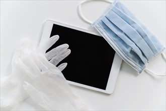 Face mask and gloves on tablet