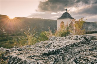Moldova, Orhei, Trebujeni Rejon, Old church on rocks at sunset