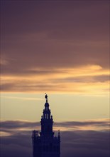 Spain, Seville, Giralda and Catherdral of Seville, Giralda tower against sunset sky