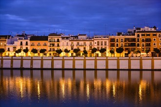 Spain, Seville, Triana, Triana neighborhood reflecting in Guadalquivir River