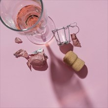 Studio shot of Champagne cork and wineglass on pink background