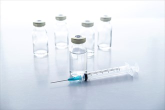 Studio shot of vials and syringe