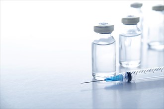 Studio shot of vials and syringe