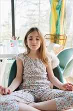 Girl (6-7) meditating at home